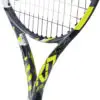 A close-up view of a yellow tennis ball against a green tennis court
