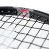 A close-up image of a tennis racket and tennis ball on a tennis court