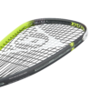 A close-up image of a tennis racket with strings, held by a player during a match.