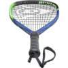 A close-up view of a tennis racket and ball on a court.